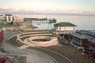 Tidal Park, site view north, ©1988<br>In collaboration with artist Douglas Hollis. A commission for a public waterfront park. <br>
View of tide clock, wave gazing gallery and terracing from upper floor of adjacent building.<br>
Concrete, stone, wood, and copper. <br>
Site: 150' x 350' <br>
Port Townsend, Washington