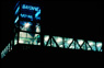 34th Street Station Bridge and Elevator Tower, detail, ©1997<br>With lighting consultant Ray Grenald. View of signage in an illumination sequence. <br>
Neon and Argon lighting, plastic, stainless steel <br>
Site: elevator tower 50'high, pedestrian bridges 330' long <br>
NJT Hudson-Bergen Light Rail Transit System, 34th Street Station, Bayonne, New Jersey
